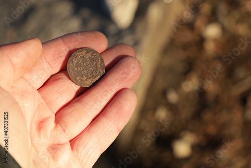 Old Austrian copper coin in hand photo