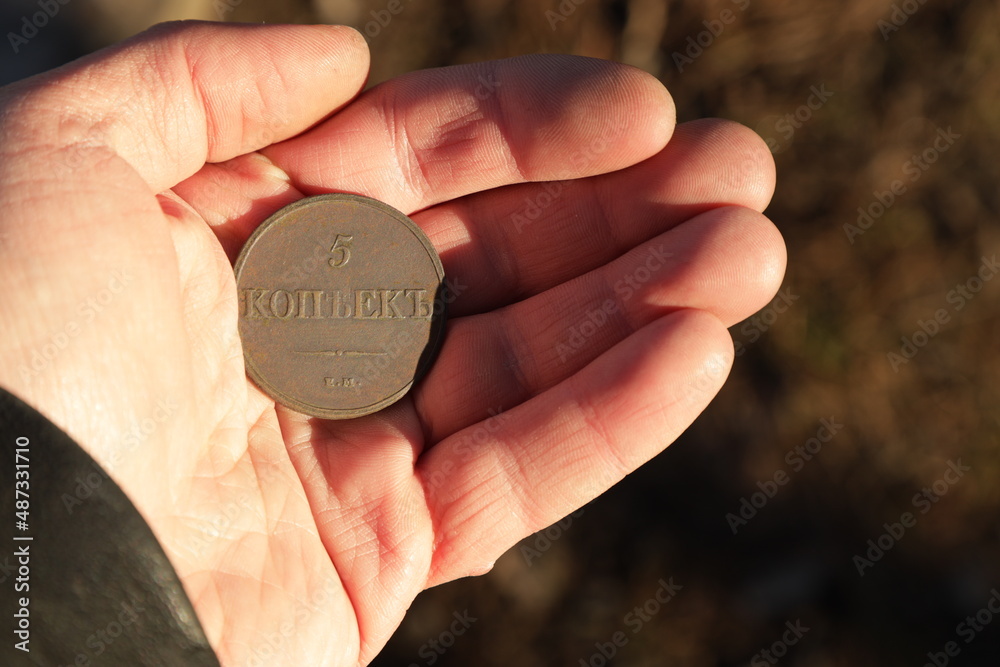 Old Russian copper coin in hand Old Russian copper coin in hand