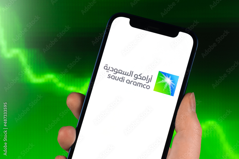 Saudi Aramco logo, stock trade on green chart. Arabian oil company, gas