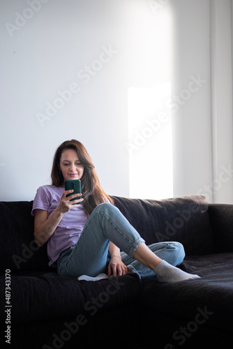 The morning routine of a young woman using her phone