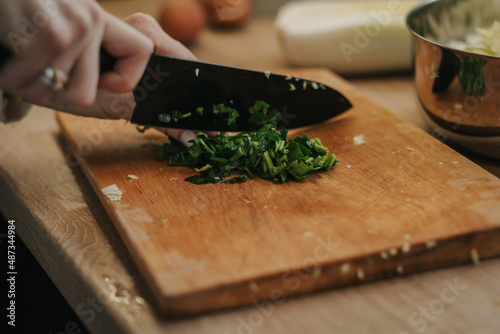 Mom cooks dinner, cuts greens