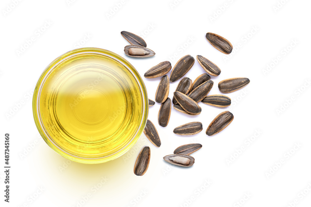 Sunflower seed oil and fresh organic sun flower seeds isolated on white background. Top view. 