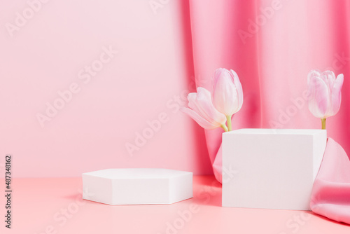 Geometric podiums with tulips and pink textile. Showcase for product display  spring concept