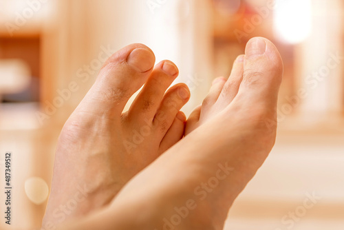 Bare male feet after a pedicure. Clean toenails and toes of an adult caucasian male. Body care concept. Selected focus
