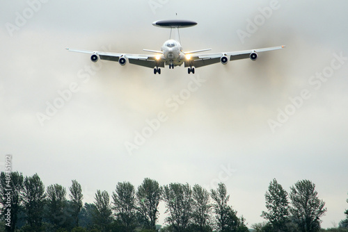 low flying Boeing E-3 Sentry American airborne early warning aircraft commonly known as AWACS.