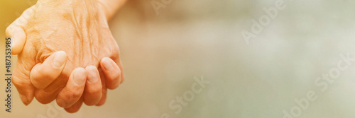 happy senior couple holding hands. hands of man and woman hold each other. romance and love and support in elderly family. family travel together. countryside life. banner. space for text. flare