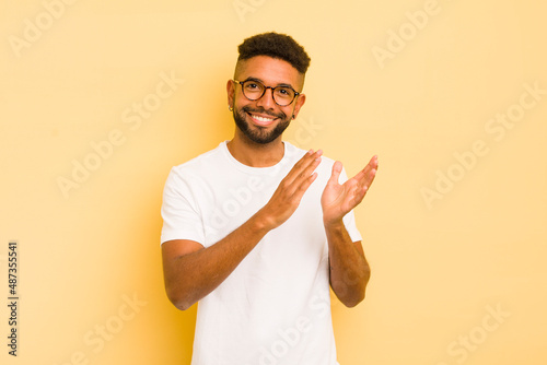 young afro man feeling happy and successful, smiling and clapping hands, saying congratulations with an applause