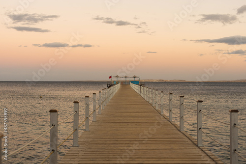 Wooden pontoon at sea  Golden sea sunset.
