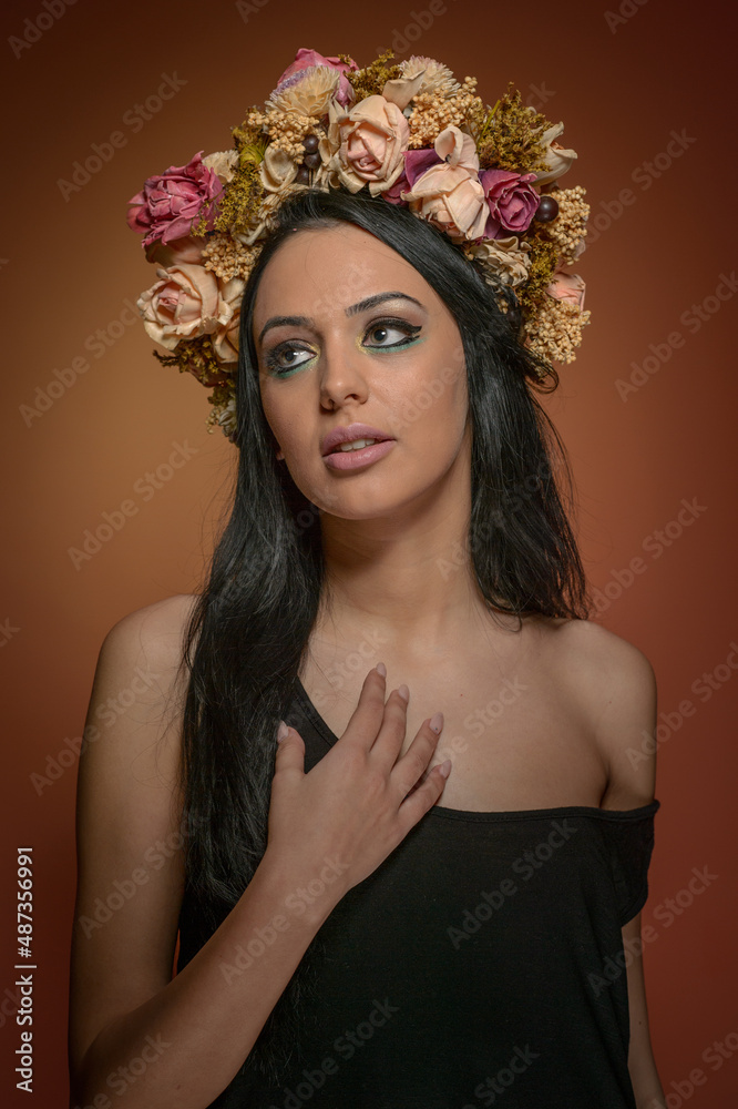 Hairstyle and Make up - beautiful female art portrait with wreath of roses, studio. Elegance. Genuine brunette, creative hairstyle with flowers. Portrait of a attractive woman with beautiful eyes. Hairstyle and Make up - beautiful female art portrait with wreath of roses, studio. Elegance. Genuine brunette, creative hairstyle with flowers. Portrait of a attractive woman with beautiful eyes.