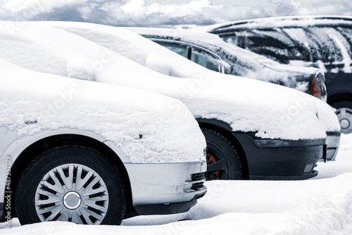 Cars covered with fresh white snow