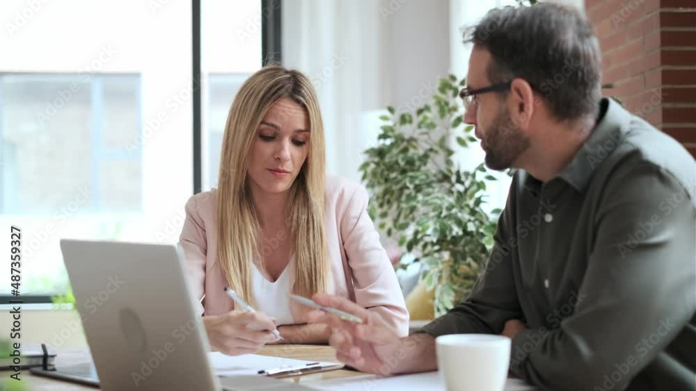 Video of smart business people working together with laptop while talking in the coworking place. Video of smart business people working together with laptop while talking in the coworking place.