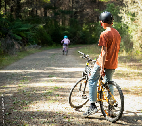 happy teen boy riding a bike on natural background, forest or park. healthy lifestyle, family day out. High quality photo