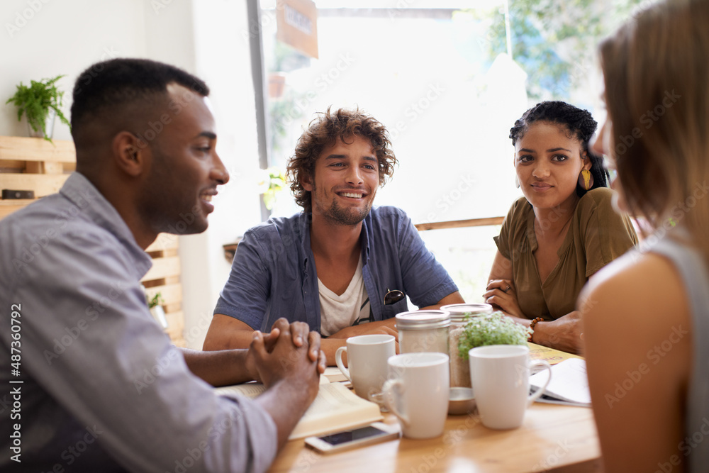 Catching up with old friends. Shot of a group of friends talking in a cafe. Catching up with old friends. Shot of a group of friends talking in a cafe.