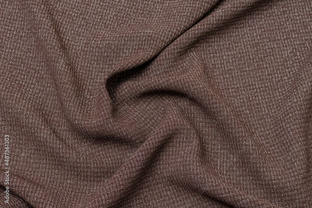 Fototapeta premium Mauled brown-colored fabric texture background. This fabric is made of cotton and polyester.