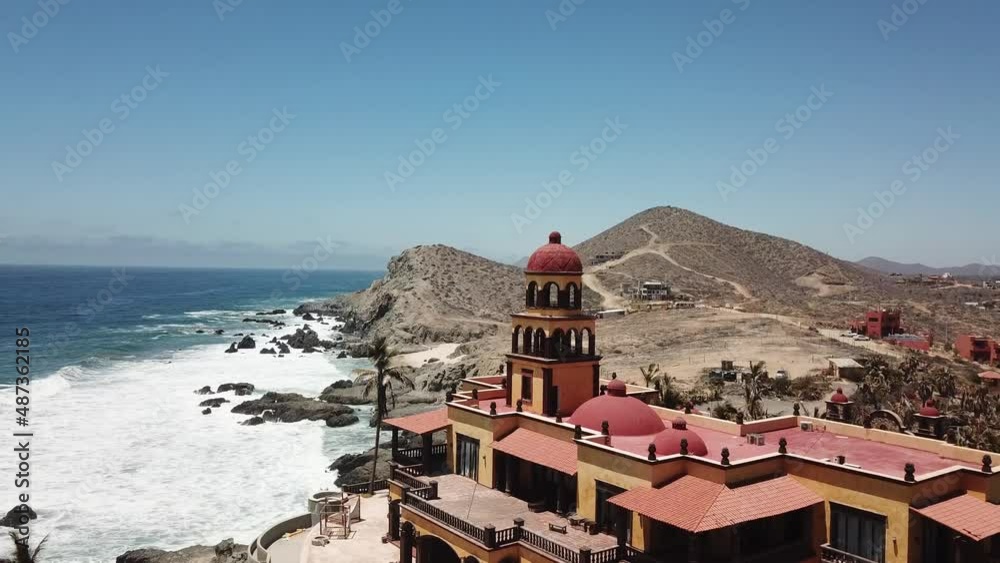 Aerial Tilt Down Revealing Grand Abandoned Red and Yellow Hotel Cerritos Beach Pacific Coast Todos Santos Baja California Sur Mexico Drone 4k