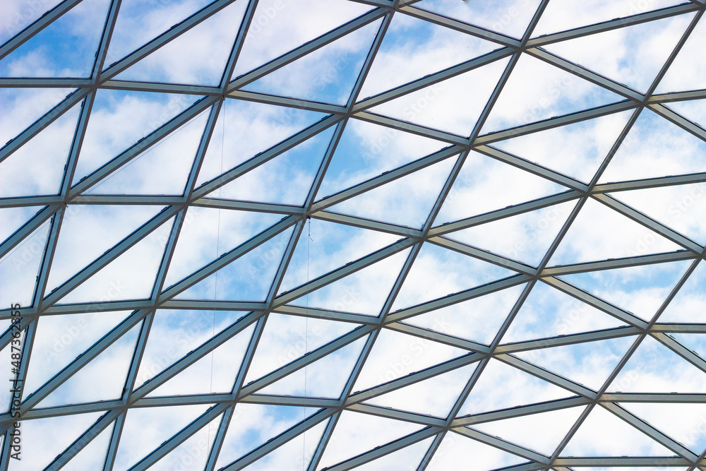 A fragment of a glass dome on the roof of the building. Geometric glass dome. Modern ceiling architecture A fragment of a glass dome on the roof of the building. Geometric glass dome. Modern ceiling architecture