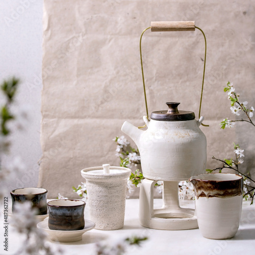 White and black handmade ceramic teapot for tea ceremony photo