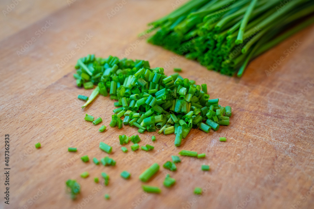 freshly cut green chives on wooden board to decorate main dish freshly cut green chives on wooden board to decorate main dish