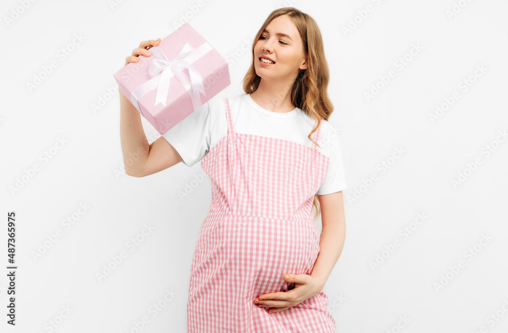 Cropped image of an attractive pregnant woman holding a gift box in her hands on a white background Cropped image of an attractive pregnant woman holding a gift box in her hands on a white background