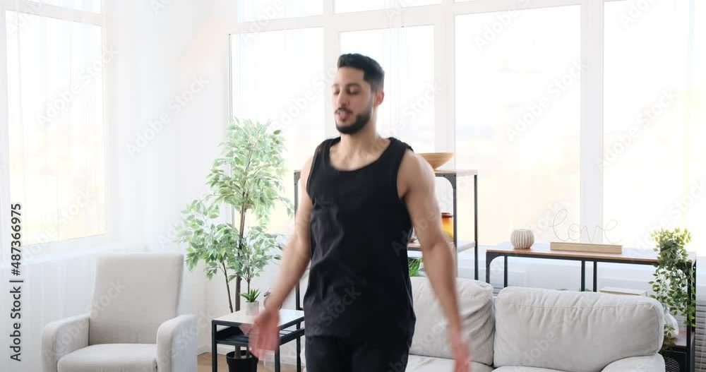 Man doing jumping jack exercise at home Man doing jumping jack exercise at home