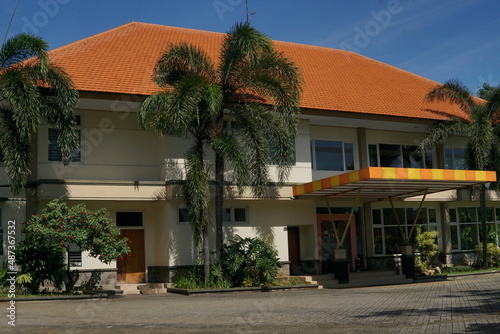 a multi-purpose building as seen from the front and looks clean against a blue sky background © Alfian