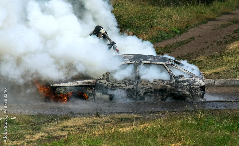 Fototapeta premium Extinguishing a burning car.