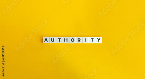 Authority Word on Letter Tiles on Yellow Background. Minimal Aesthetics.