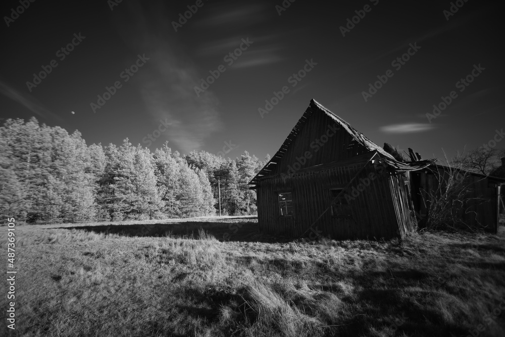 Old abandoned damaged wooden house in black and white Old abandoned damaged wooden house in black and white