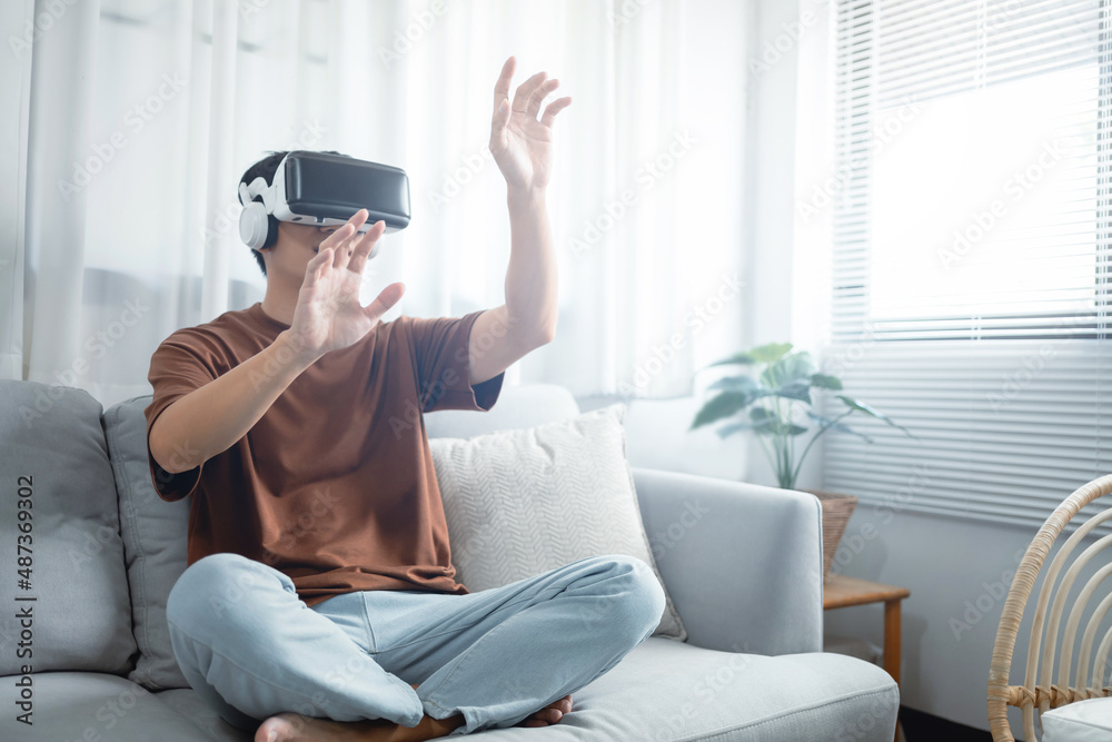 Asian man using VR headset in glasses of virtual reality technology VR experience Future technology Asian man using VR headset in glasses of virtual reality technology VR experience Future technology