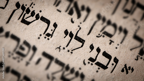 Obraz na płótnie Hebrew word in Torah page. English translation is name Levi, the third son of Jacob and Leah. Founder of Israelite Tribe of Levi. Great-grandfather of Aaron, Moses and Miriam. Selective focus. Closeup w salonie
