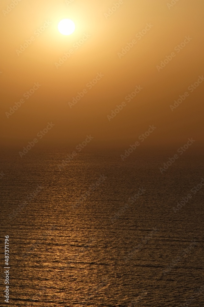 Amazing orange sunset and view of the Aegean Sea in Santorini Greece