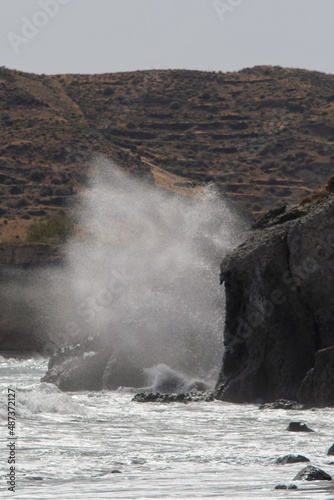Fototapeta Naklejka Na Ścianę i Meble -  Big waves crushing on rocks at the famous red beach in Santorini Greece
