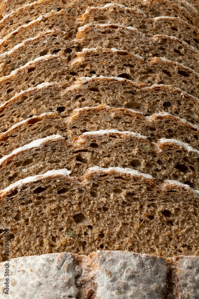 Sliced Pavé bread, multi grain bread, seen from above full frame close up as background
