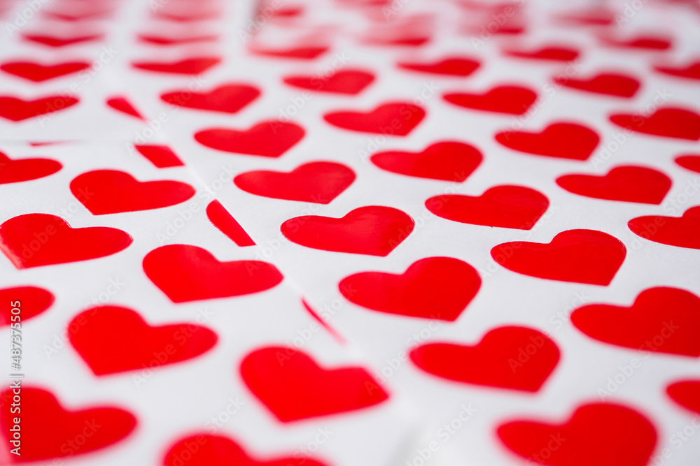 Close up red heart sticker on white paper Close up red heart sticker on white paper