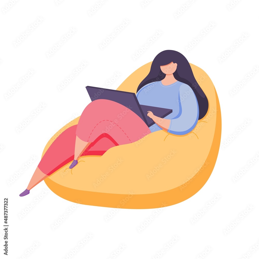 Girl sitting in a bean bag chair and working on a laptop.