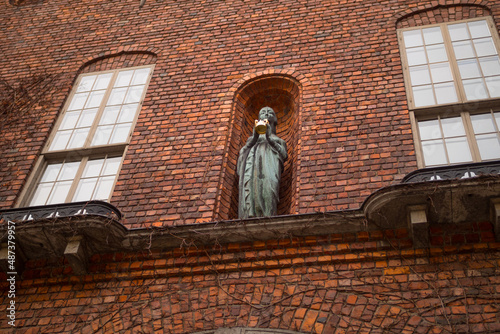 Stockholm, Sweden. City hall architectural brick wall close up and statue. Yearly Nobel prize banquet takes place inside, in the Blue Hall.