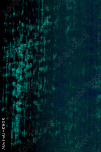 Surface of wrapping neon film in intense electric green and dark blue