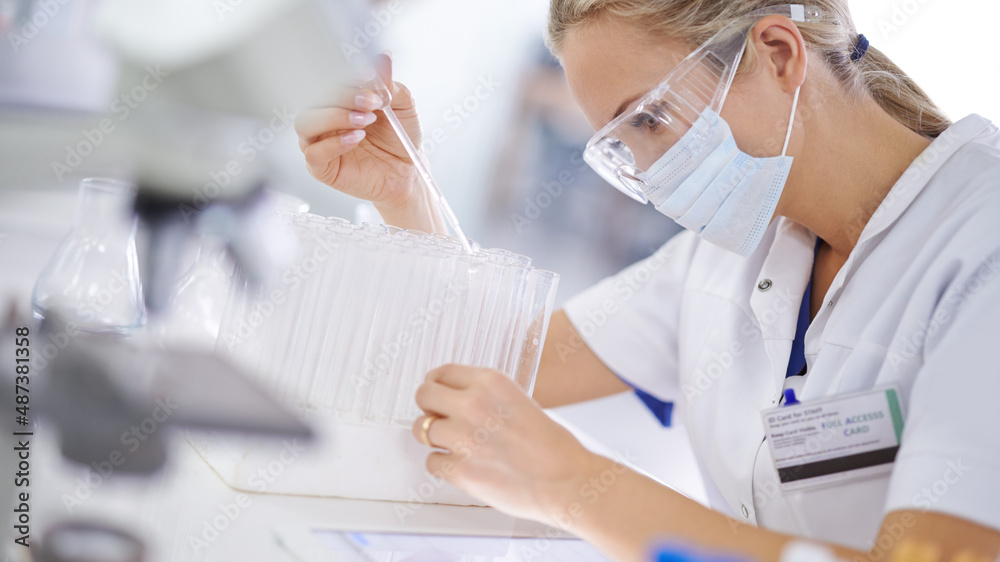 Breaking scientific boundaries with her research. A young scientist conducting an experiment in her lab. Breaking scientific boundaries with her research. A young scientist conducting an experiment in her lab.