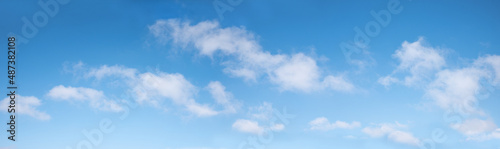 gradient blue sky panorama with soft cumulus clouds