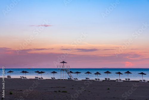 Beach umbrellas at a beautiful romantic sunset on Ulcinj Montenegro