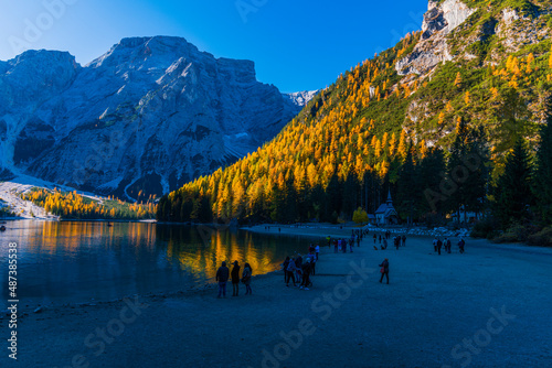 Autumn and golden reflections on Lake Braies. Park of the Dolomites.