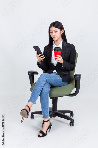 Asian business woman sit chair using smartphone