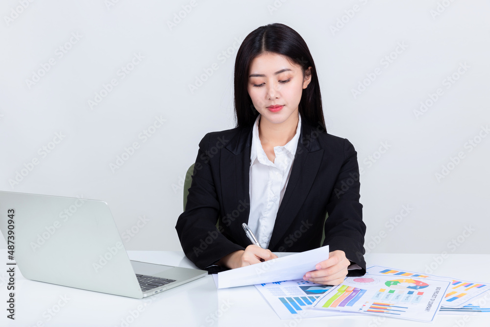 Asian business woman sit at desk in office. Asian business woman sit at desk in office.