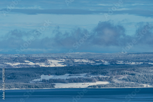 Cultural landscape of Hedmark, Innlandet, by Lake Mjøsa, Norway, in winter. photo