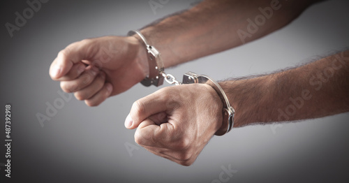 Caucasian male hands in handcuffs. Arrest