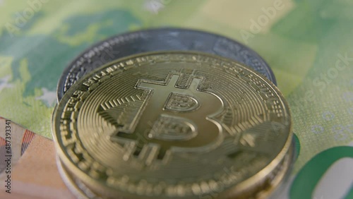 bitcoin coins lie on euro banknotes close up photo