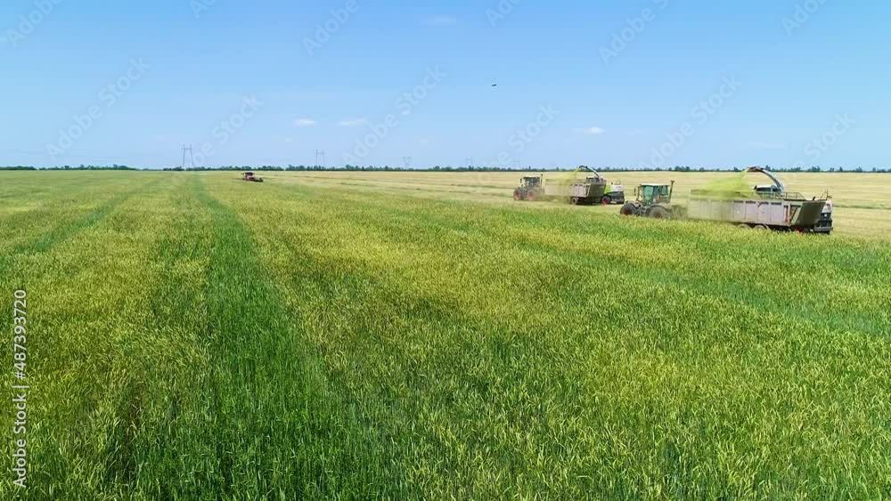 Bird's eye view of tractor and truck working in the field