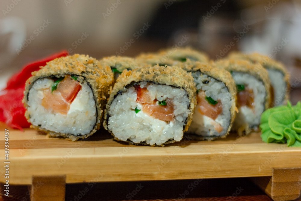 Hot fried Sushi Roll with shrimp, cucumber and cheese philadelphia. Sushi menu. Japanese food. Futomaki Hot fried Sushi Roll with shrimp, cucumber and cheese philadelphia. Sushi menu. Japanese food. Futomaki