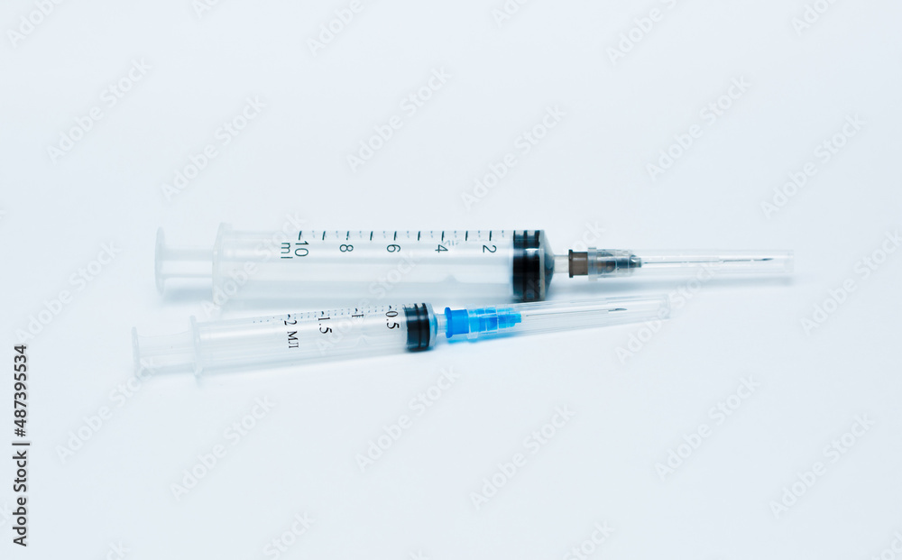 Medicinal or cosmetic ampoules jars of vaccines isolated on white background as a concept of cosmetology medicine and treatment with syringes injections. Medicinal or cosmetic ampoules jars of vaccines isolated on white background as a concept of cosmetology medicine and treatment with syringes injections.