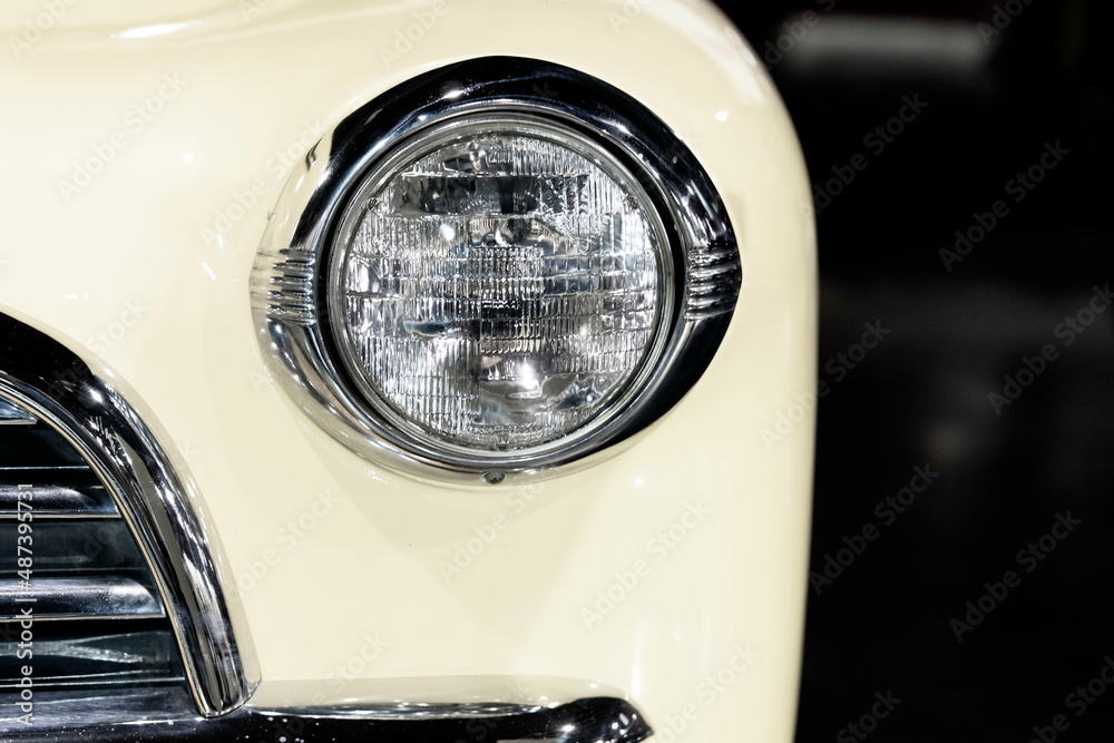 Classic Desaturated Retro looking Car Headlight with copy space and blurred background